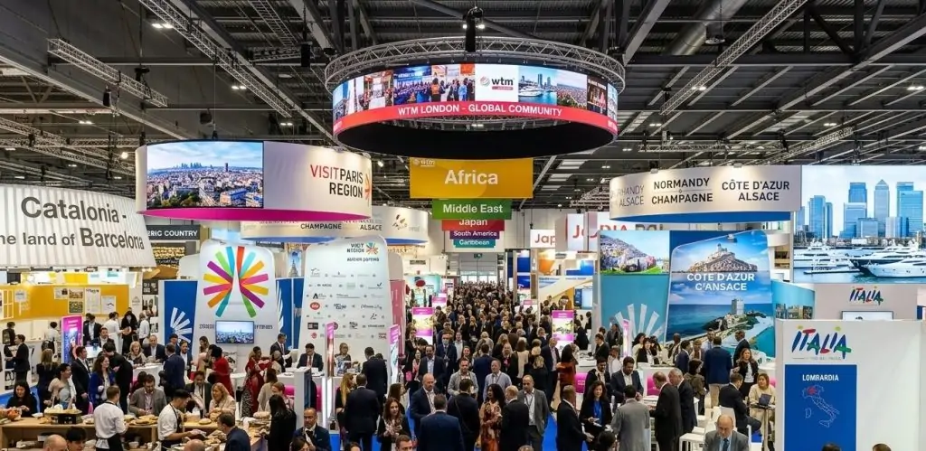 World Travel Market London Hostess welcoming visitors at an international tourism exhibition stand.